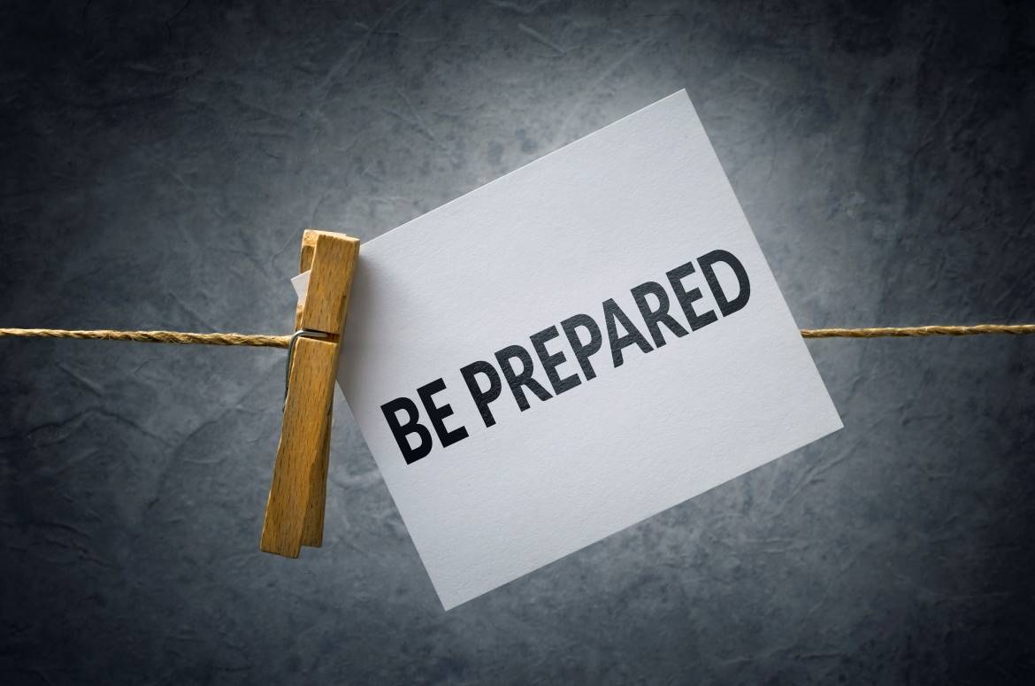 Paper that says "BE PREPARED" pinned on a clothes line